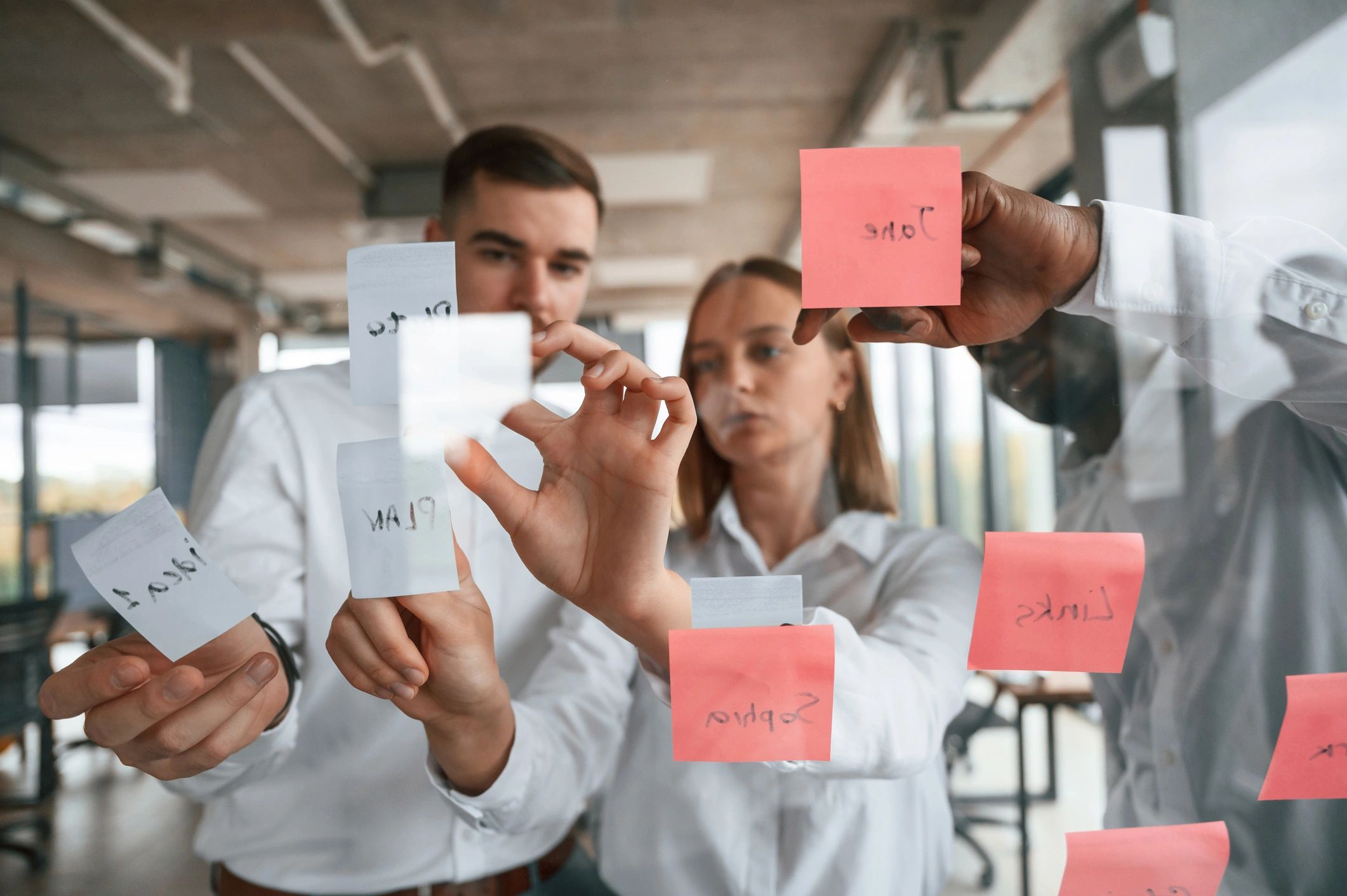 Team planning on glass with sticky notes